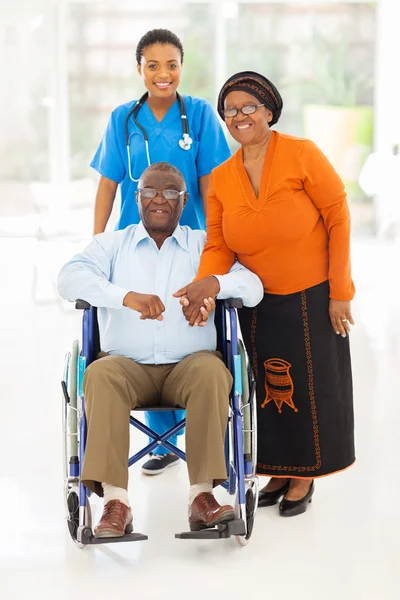 African female healthcare worker with senior couple