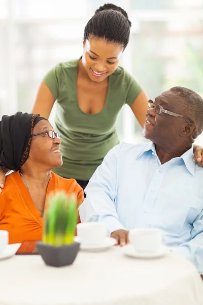 African girl talking to senior parents