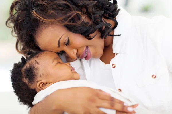 Loving african mother holding sleeping baby daughter