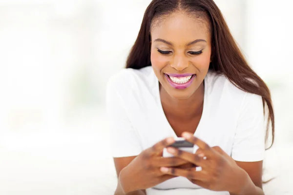 Young african american woman using smart phone