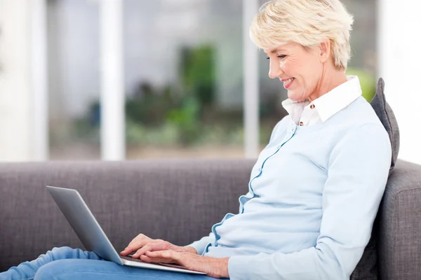 Elderly woman using laptop computer