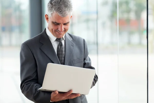 Senior businessman using laptop computer