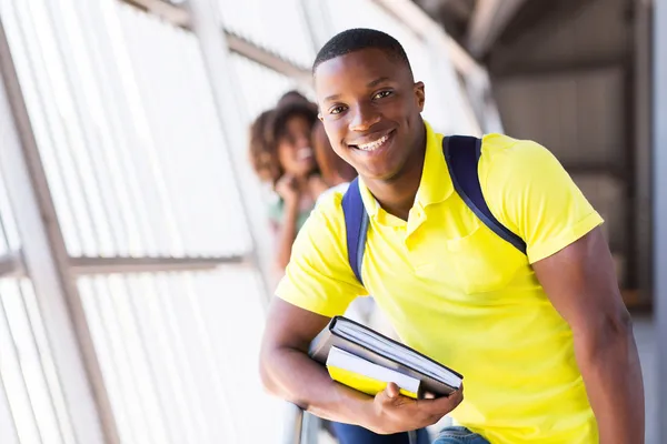 Male student holding books