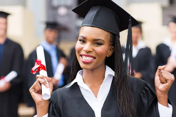African american female graduate with hands up