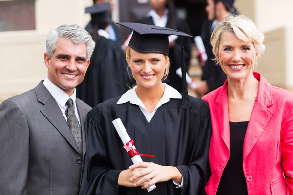 Female graduate with parents at graduation
