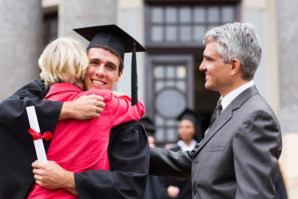 Graduate hugging his mother
