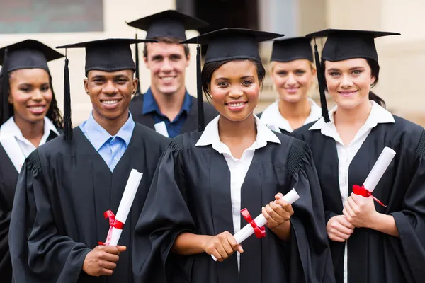 Multiracial graduates holding diploma