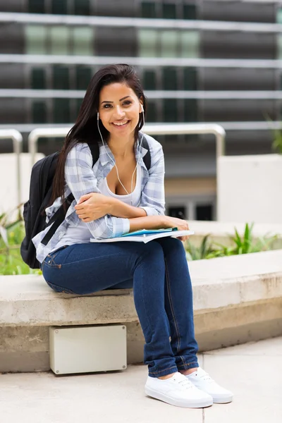 Young college student sitting outside campus building