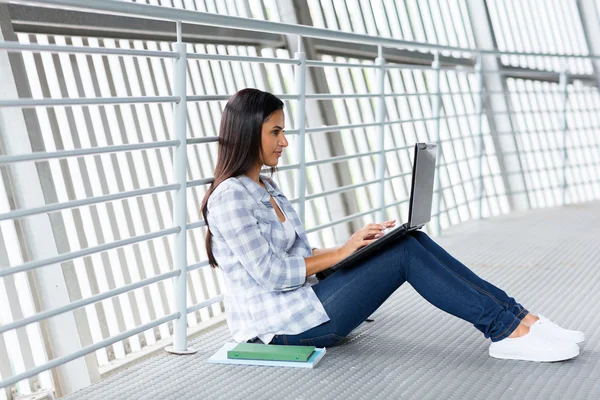 Female univesity student working on laptop computer