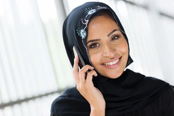 Muslim woman talking on phone