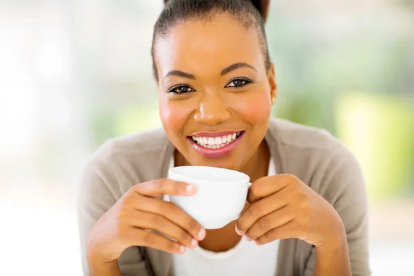 African woman drinking coffee in the morning