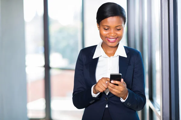 African american businesswoman texting on smart phone