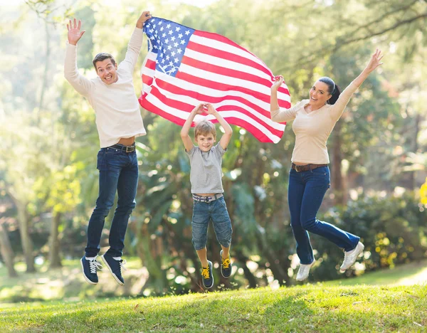 American family jumping with USA flag