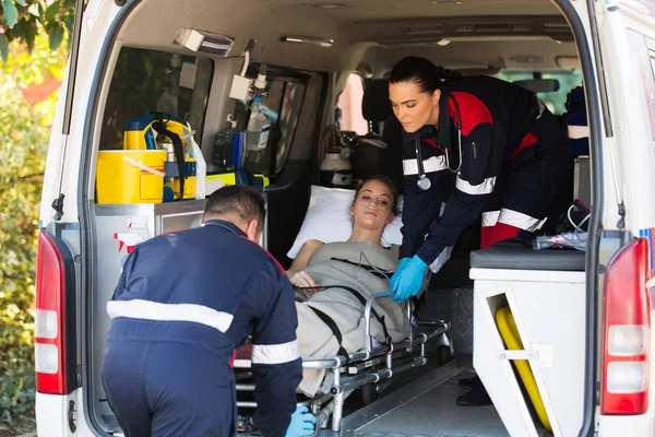 Emergency medical staff transporting patient