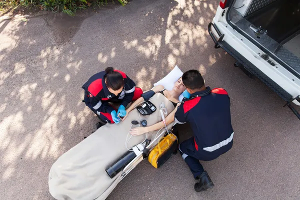 Paramedic team providing first aid