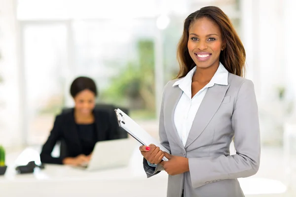 African businesswoman holding clipboard