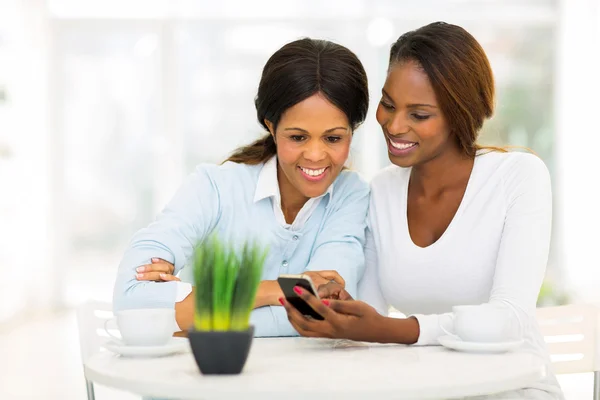 African mother and daughter using smart phone