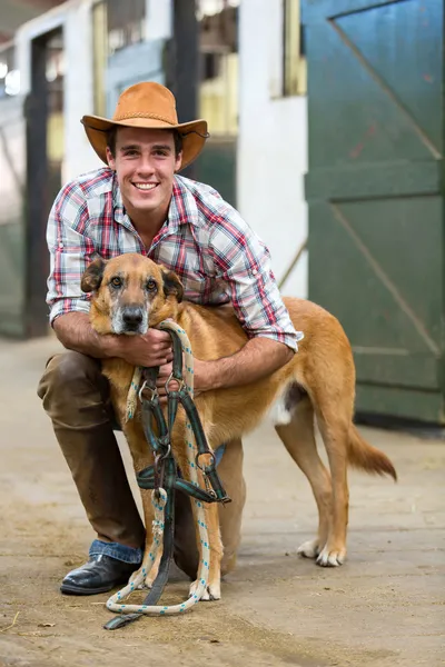 Horse farm owner and his dog