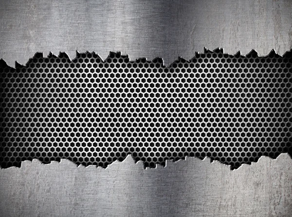 Silver hexagon metal grate background in ripped hole