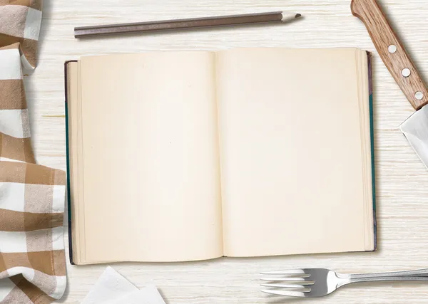 Blank cooking recipe notes or book with pencil on kitchen table