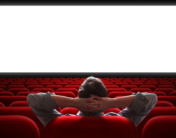 Man sitting alone in empty cinema hall