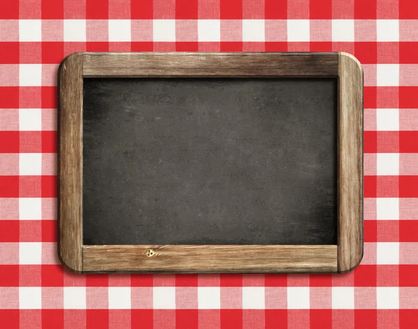 Chalkboard or blackboard on picnic tablecloth