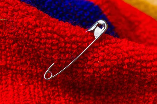 Safety pin pinned to the texture fabric