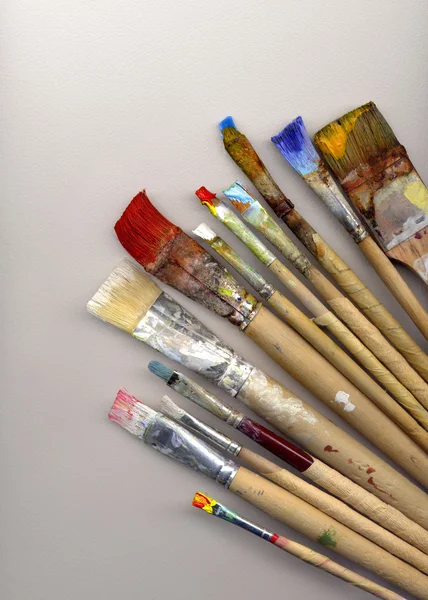 Paint brushes lying on watercolor paper