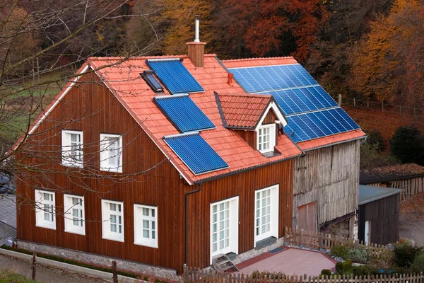 House with solar panels sun heating system on roof