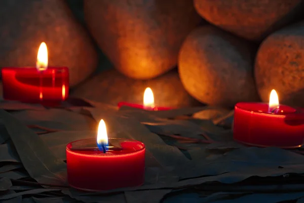 Candles are lit on the background of the sauna stones. Preparing
