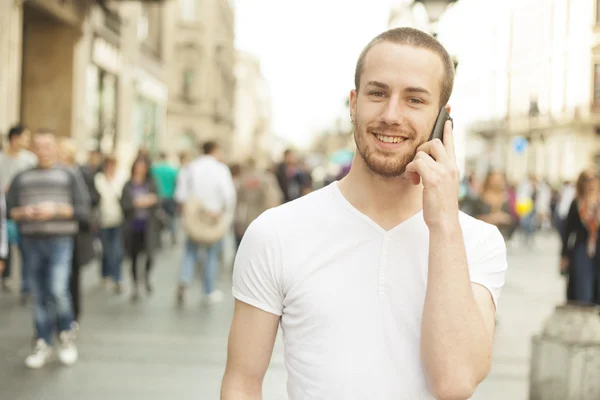 Man with mobile phone walking on street