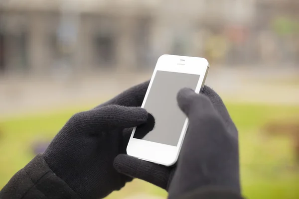 Smartphone in hand with gloves