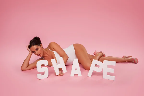 Beautiful shapely woman with the word SHAPE