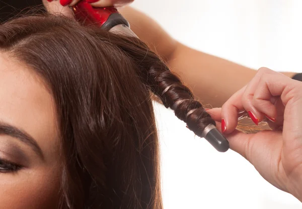 Woman having her hair curled