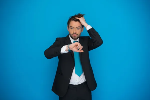 Businessman in rush looking at his watch , running late