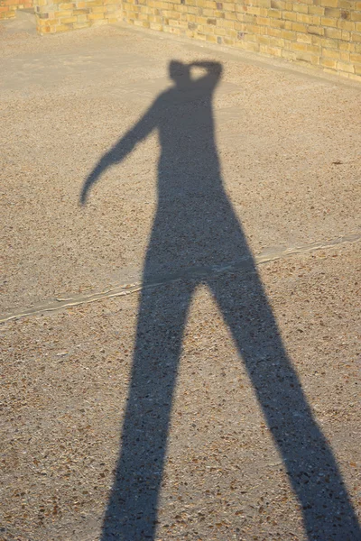 Elongated shadow of a man