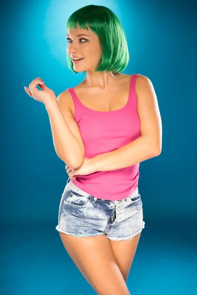 Cute slender young woman with green wig