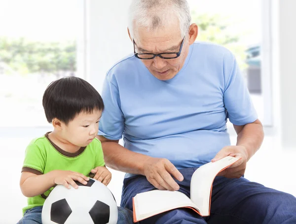 Grandfather reading a story book for his grandson