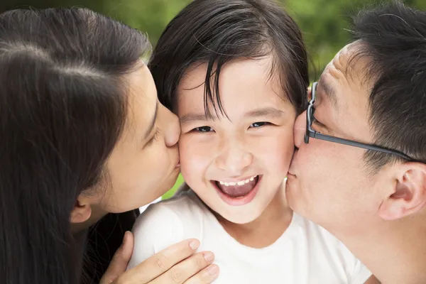 Happy asian family in kissing