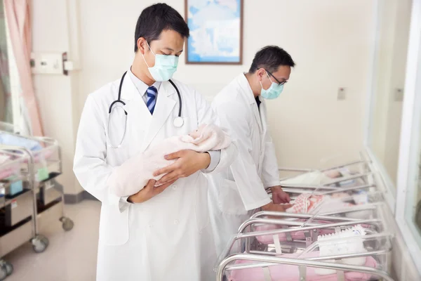 Gynecologist doctor holding a newborn baby