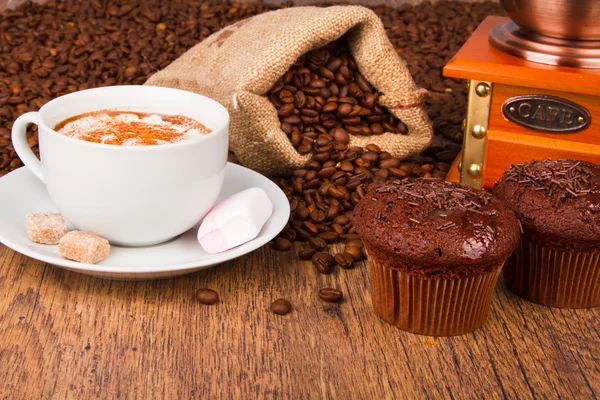 Coffee cup with chocolate muffins