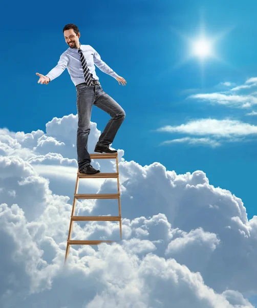 Young confident businessman standing at the top of ladder high in the sky lends a helping hand
