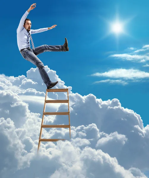 Young confident businessman standing at the ladder high in the sky falls from the top