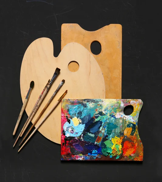 Paint brushes and wooden palette used for painting