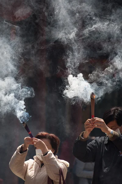 Group of burning incense and praying