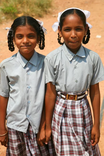 Sisters walking back from school in India