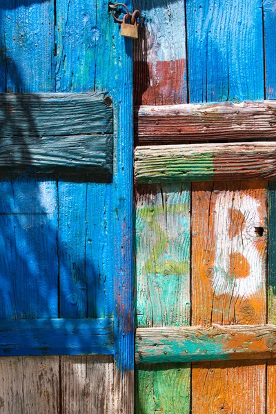 Close-up of a painted door with a lock