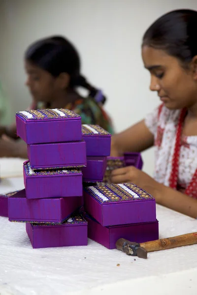 Woman artisan working on on fair trade artifacts in India