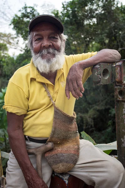 Portrait of an old farmer man with a white bear in Colombia