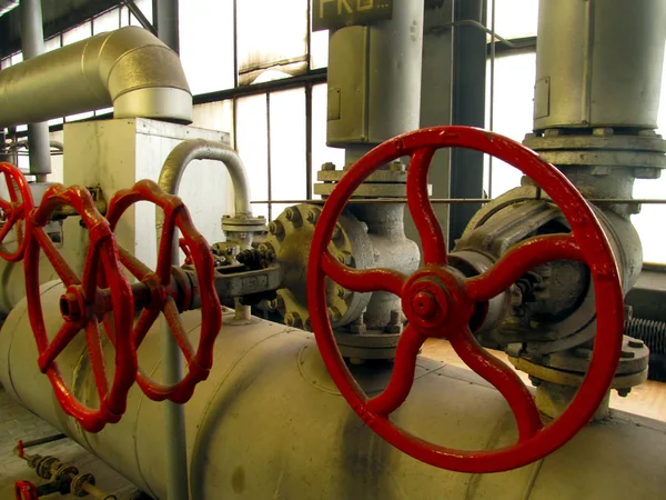 Pipes and valves with red knobs